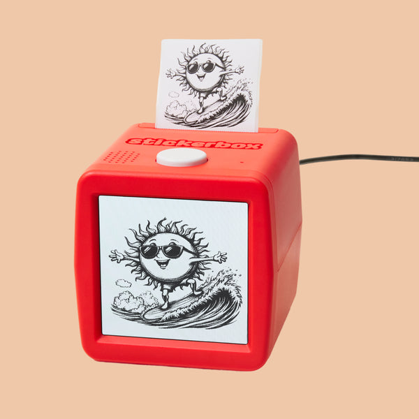 Red Stickerbox with a screen showing a sun surfing in the ocean, and it printed a sticker showing what's on the screen.